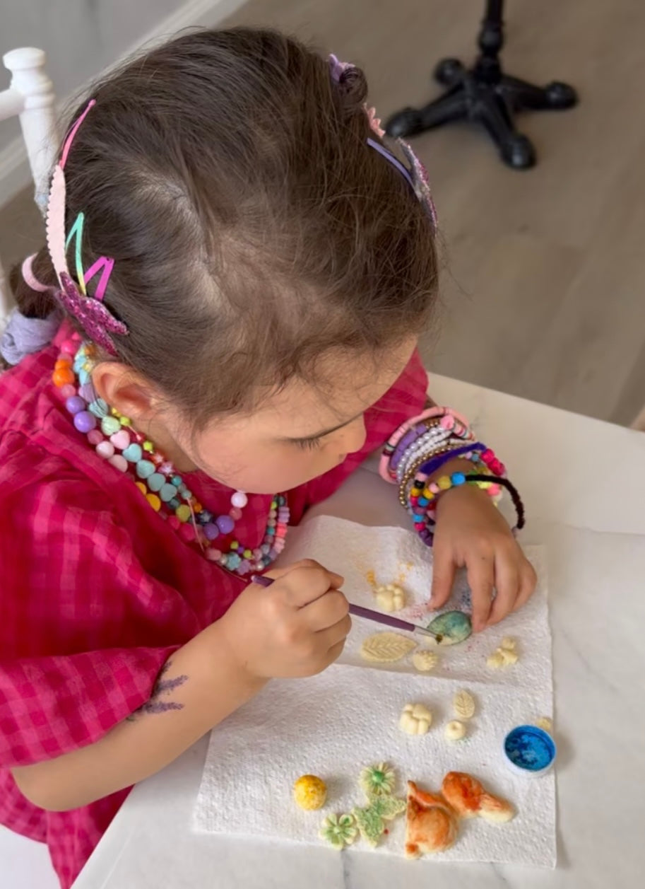 Child colouring a chocolate Easter egg