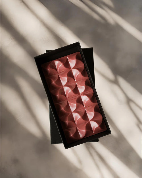 Ruby chocolate block in a black box on a light background